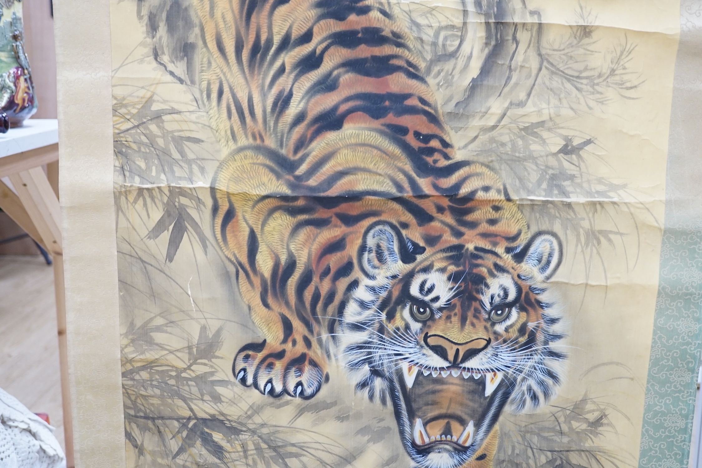 A Japanese ‘tiger’ scroll painting. Condition - fair